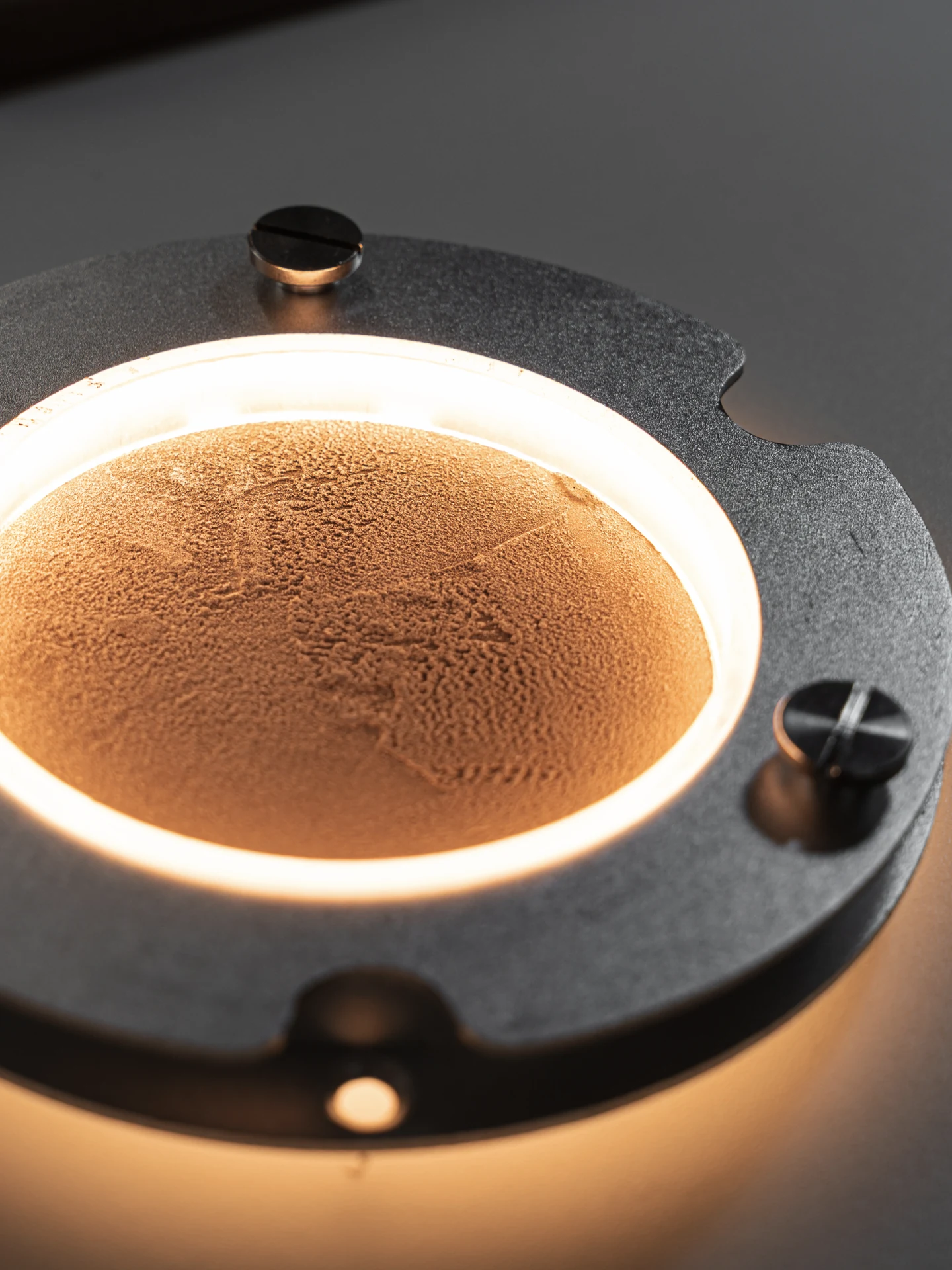 Strata Pendant, black quartz sand + metal or wood surface, by Rollo Studio