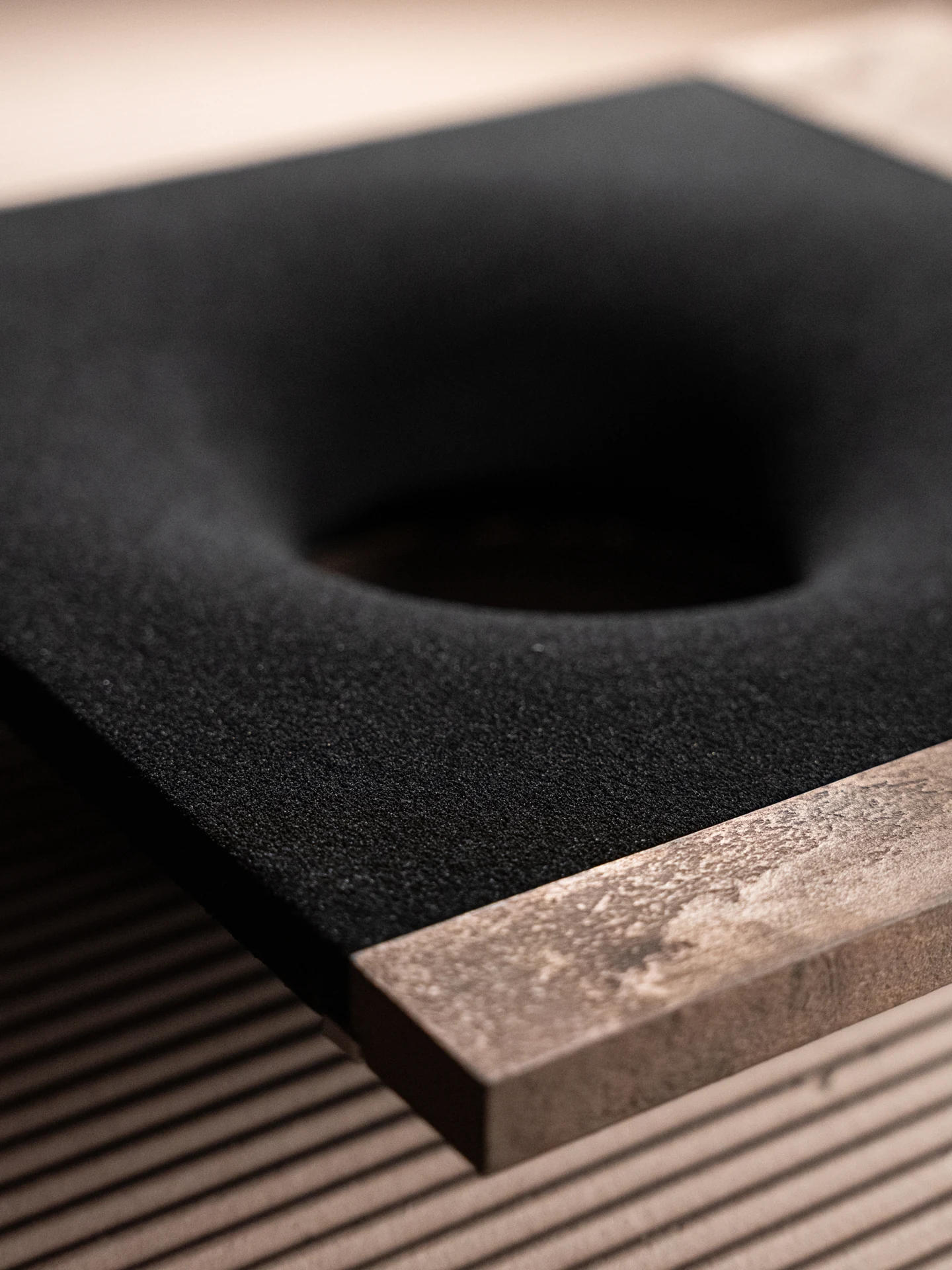 Strata Wall Light, black quartz sand + metal or wood surface, by Rollo Studio, view 6